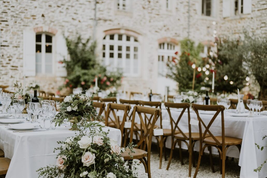 Refined wedding tables arranged in the château courtyard