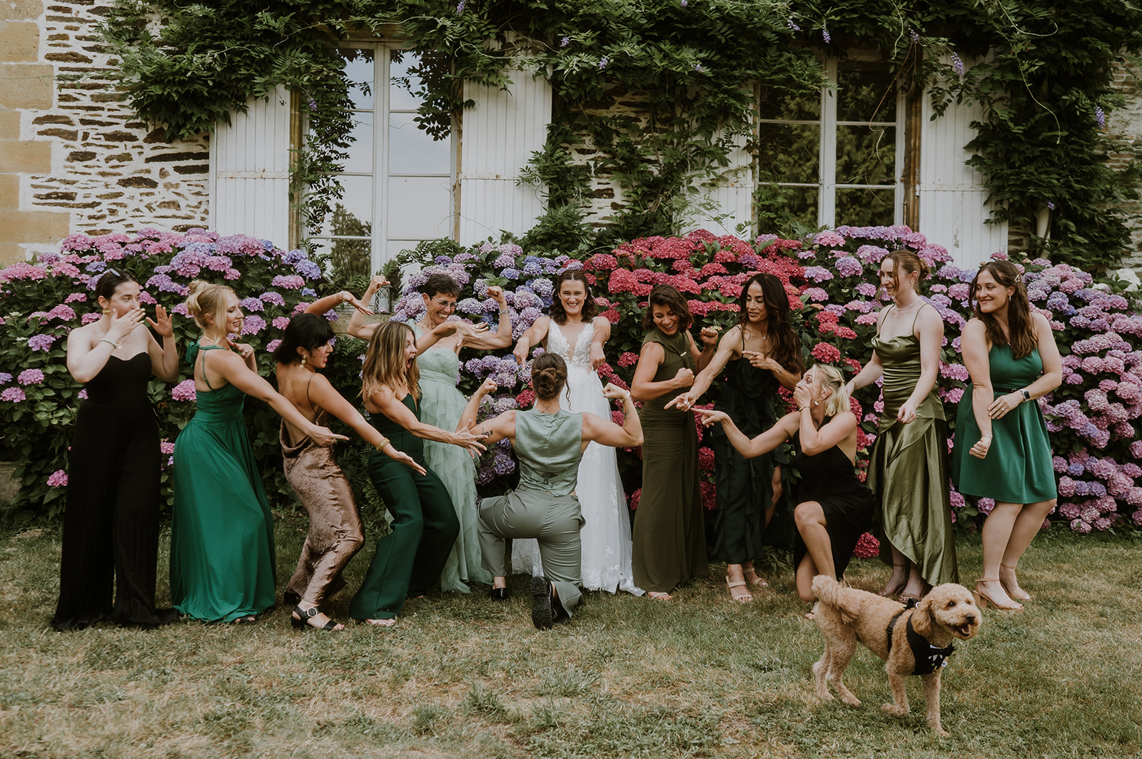 Wedding party celebrating beside the château hydrangeas