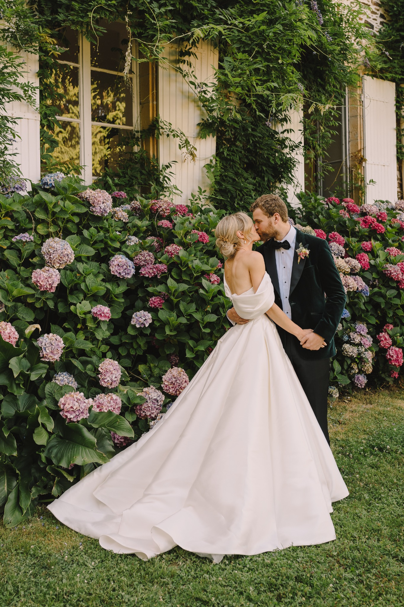 Wedding couple among the hydrangeas at Château d’Oche