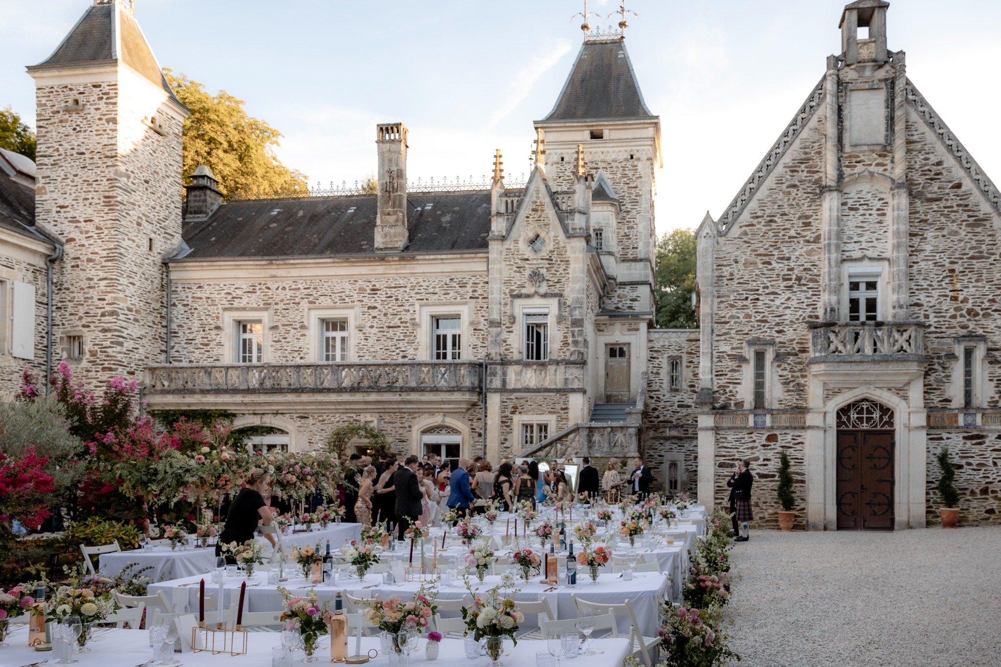 Wedding dinner among abundant flowers in the château courtyard