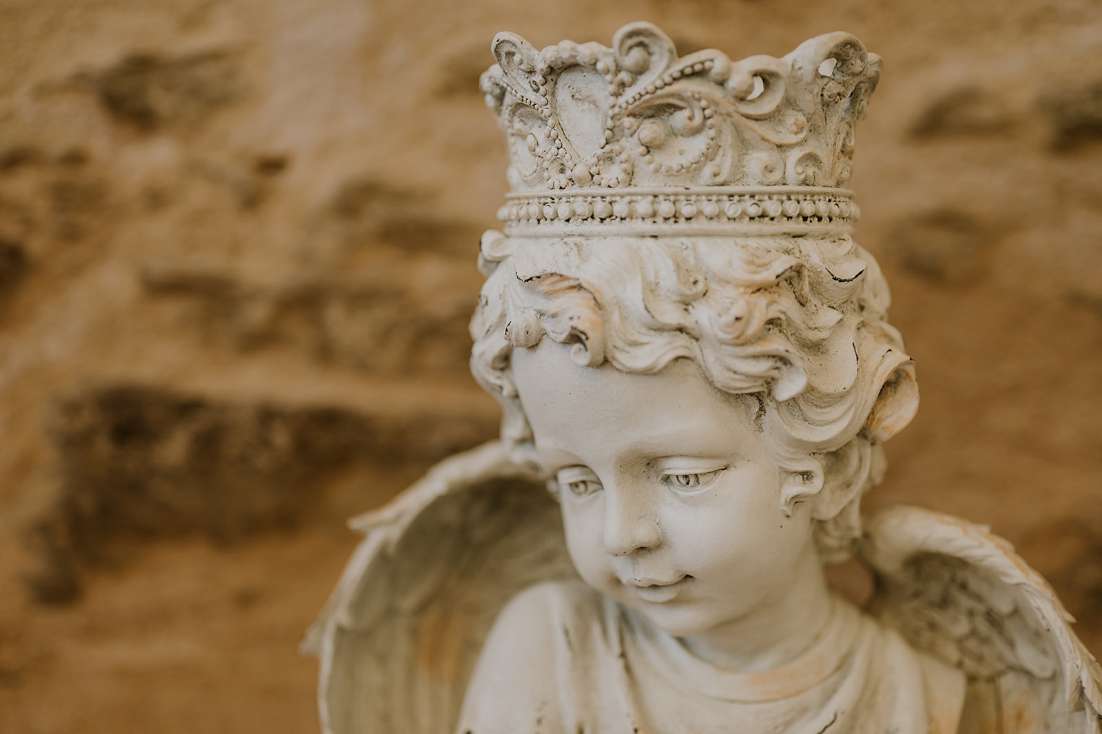 A crowned angel detail within Château d’Oche