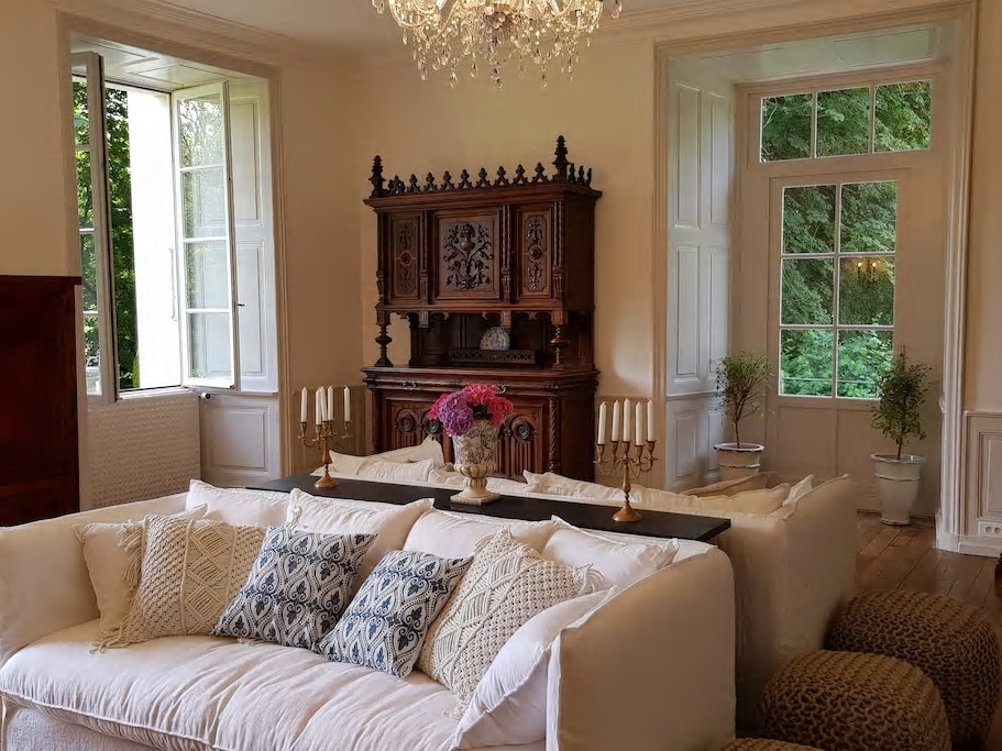 Elegant château salon with chandelier and tall windows
