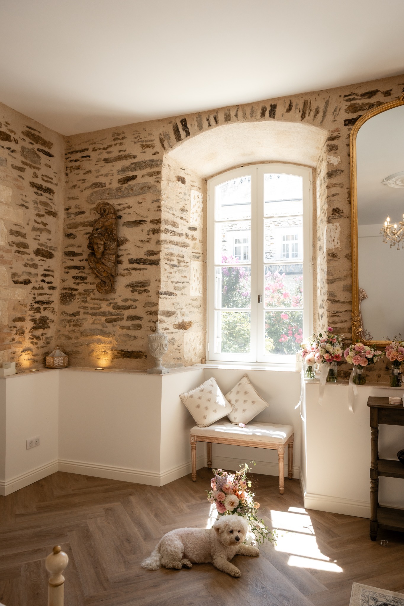 A flower-filled château interior in morning light