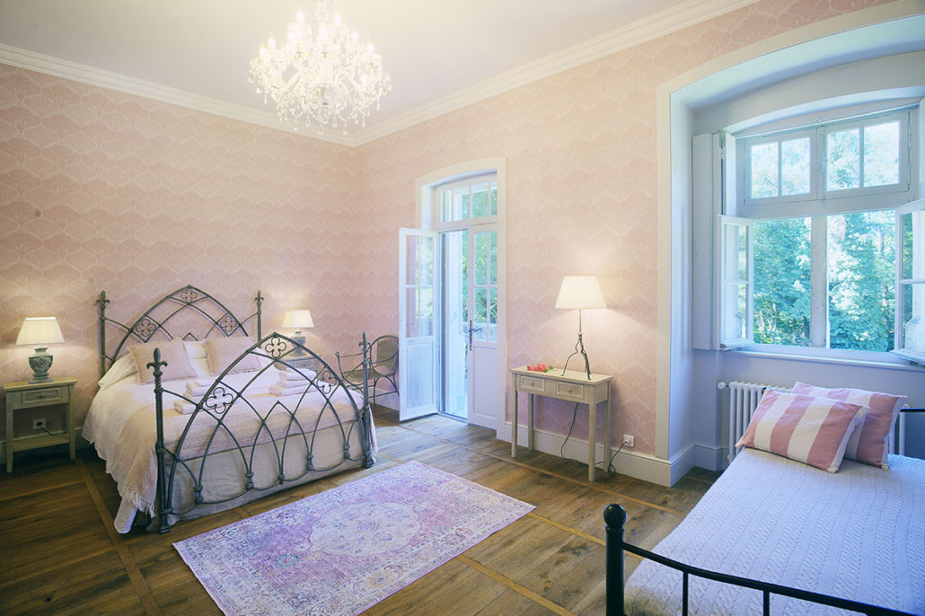 Pink château bedroom with crystal chandelier